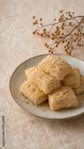 Traditional Korean Injeolmi Rice Cakes with Soybean Powder in Elegant Rustic Setting