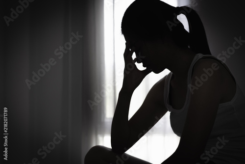 Konstfotografi Sad woman sitting alone, symbolizing a victim of abuse and human trafficking, raising awareness about women's rights, safety, freedom, protection and recovery