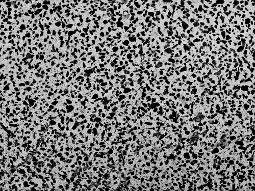 Top view close up of black and white terrazzo stone floor texture with dark speckles seamless pattern for design backdrop