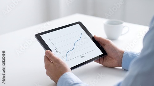 of hands holding tablet computer displaying rising line graph chart, business growth, financial data analysis, stock market trend, increasing value over time, digital technology