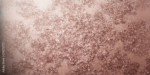 Close-up of rose gold glitter with a soft, diffused light creating a sparkling, luxurious texture. The glitter is scattered across the surface.