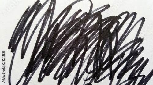 Black marker scribble on white paper background