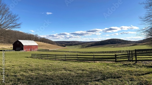 A rural Pennsylvania farm with a red barn, rolling hills, and green pastures under a blue sky.
