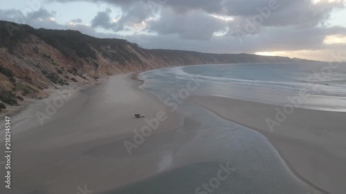 High push in forward drone ocean shoreline waves 4wd car beach sunset 