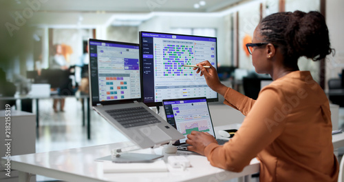 Bild auf Leinwand Manager Carefully Plans Employee Shifts Using Scheduling Software