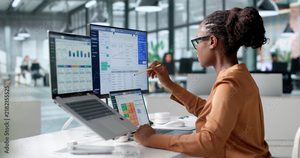 Obraz premium Insurance Underwriter Carefully Reviews Policy Data Using Laptop