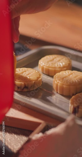 Brushing egg liquid on handmade mooncake for Mid‑Autumn Festival