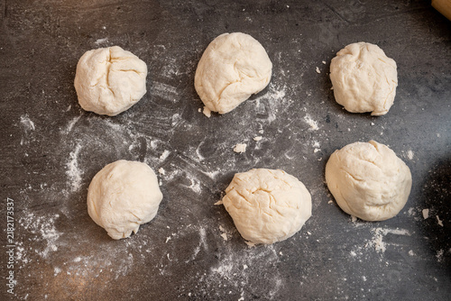 homemade dough for flat bread on a floured bench
