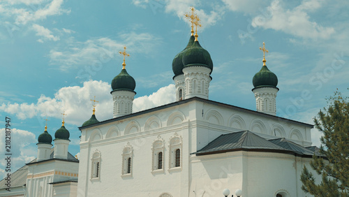 Photography White stone church with multiple green onion domes topped with golden crosses, s