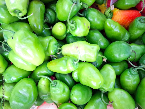 Bild auf Leinwand Abundant pile of fresh green chili peppers for spicy culinary market ingredients