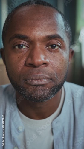 Contemplative male face in soft light setting, Expressive portrait of man showing resilience and reflection