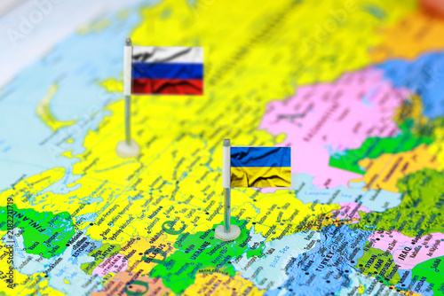 Small Flags of Russia and Ukraine Pinned on a World Map