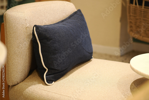 Quadro su tela Couch with blue pillow in a cozy indoor space
