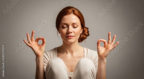 Serene woman meditating with eyes closed and hands in mudra. Achieving inner peace and mental clarity.