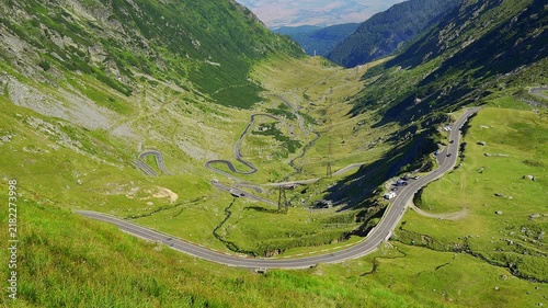 Scenic Transfagarasan road descending through a green Carpathian mountain valley in Romania