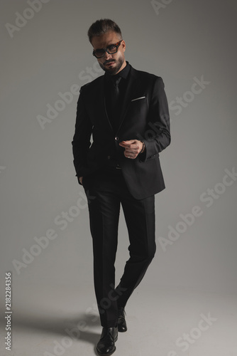 Fotografie Elegant man in suit walking and looking forward