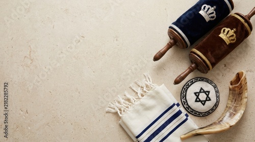 Torah scroll with tallit prayer shawl and shofar horn for jewish religious holiday celebration and worship