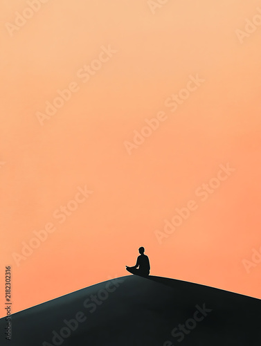 Silhouette of a person meditating on a sand dune at sunset