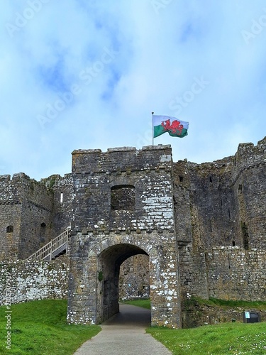 Photography The historic stone gatehouse of Carew Castle stands beneath the Welsh dragon flag in Pembrokeshire, Wales