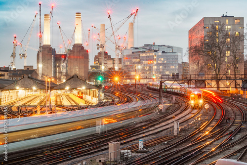 Battersea Power Station and Busy Railway Network During London Redevelopment Battersea Power Station behind busy railway tracks and trains in London, showing transport infrastructure, construction and