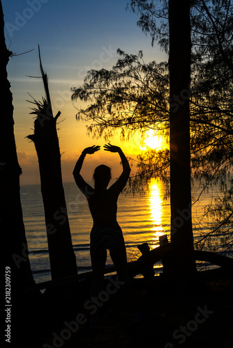 Woman with silhouette exercise and sunrise