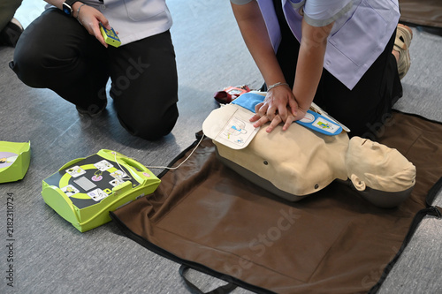 CPR training. Healthcare professional practicing CPR chest compressions on a medical dummy during first aid training session. Concept of emergency response, life-saving skill, and medical education.