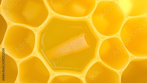 Golden honeycomb cells filled with liquid honey and a small tube yellow