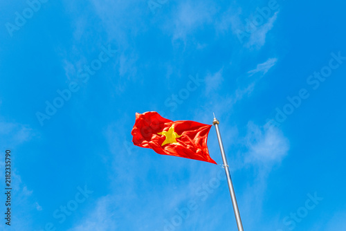 Vietnamese flag waving again the blue sky background in Vietnam