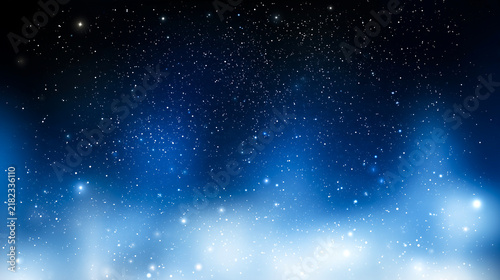 深い青の夜空に光の粒が広がる幻想的な背景