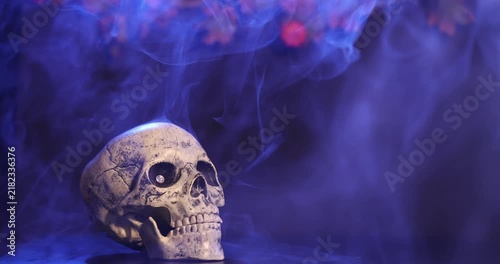 Skull with smoke effects on a dark background, iconic Halloween gothic composition for holiday decorations and backdrops. 
