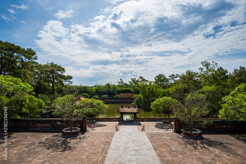 Mausoleum of Emperor Tu Duc garden area with lake, a historical landmark site in Hue, Vietnam.