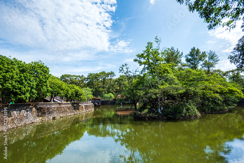 Mausoleum of Emperor Tu Duc garden area with lake, a historical landmark site in Hue, Vietnam.