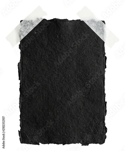 Black textured paper taped to white background.