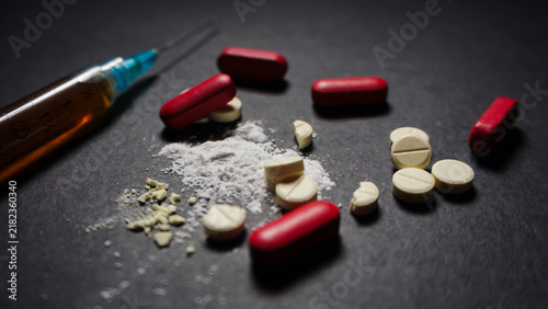 Canvastavla Prescription drugs in pills and powder form with red and white colors on black background