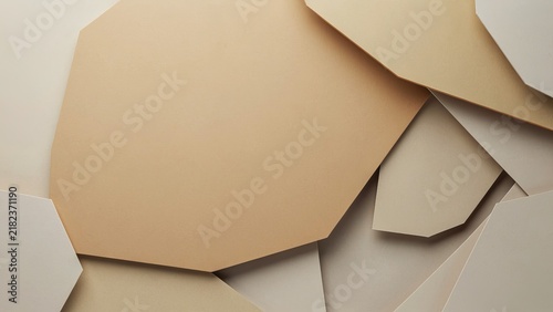 Overlapping paper shapes in warm earth tones form an elegant minimalist geometric collage.