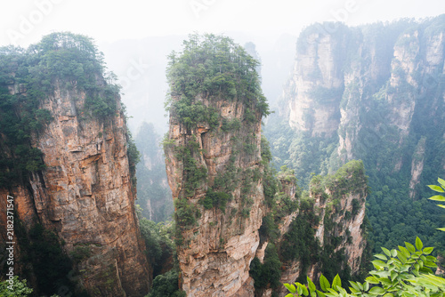 Konstfotografi Towering sandstone pillars emerge from mountain mist at Zhangjiajie National For