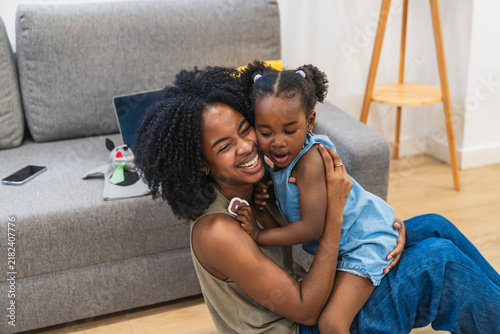 Konstfotografi Happy african american mother embracing her daughter with love and joy, spending