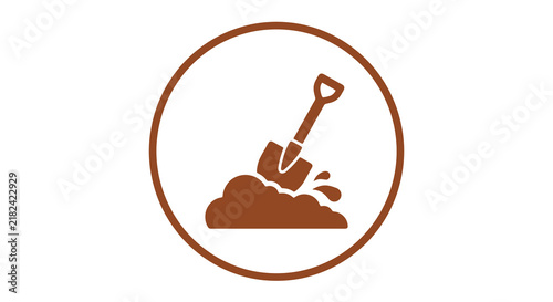 Gardening shovel digging soil in circular frame.