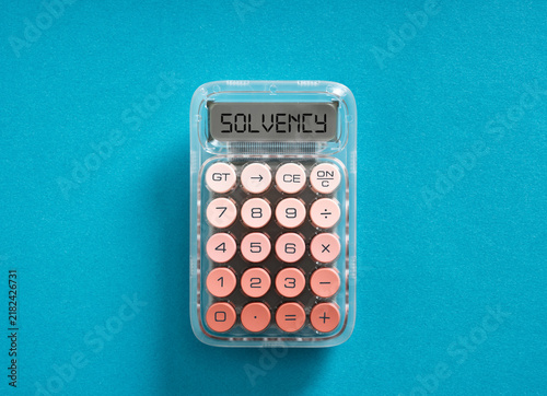 Obraz na płótnie Calculator displaying solvency concept on blue background
