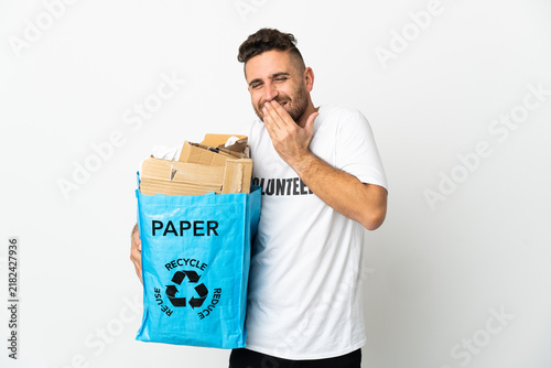 Canvastavla Caucasian man holding a recycling bag full of paper to recycle isolated on white