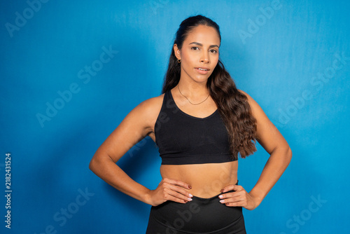 Quadro su tela Woman posing confidently wearing black sports bra