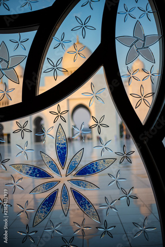 Stained glass detail on the beautiful Grand Mosque building in Abu Dhabi with beautiful flower shape patterns and geometric textures