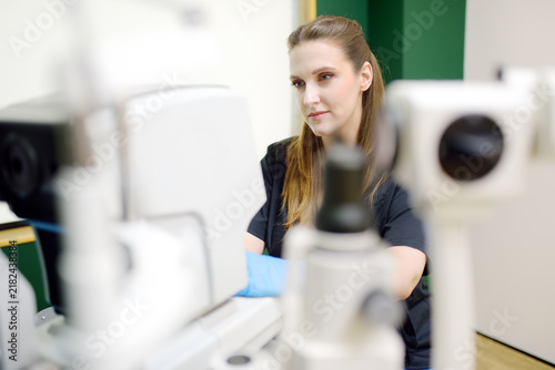 Portrait of a young ophthalmologist at their workplace. Specialist consultation, vision testing, early diagnosis, and treatment of eye diseases.