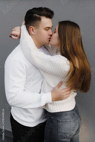 Canvastavla Young couple embracing in a studio portrait, in a natural standing