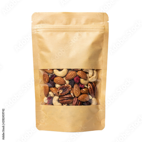 Brown kraft paper pouch with a clear window containing a mix of assorted raw nuts and dried berries isolated on a transparent background