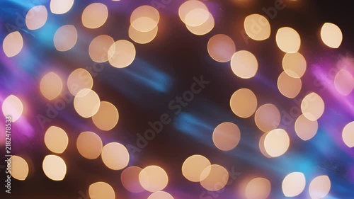 Soft bokeh lights dancing in warm golden hues with subtle blue and pink streaks during a gentle camera drift