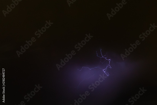 Naklejka Dramatic Forked Lightning Illuminates Storm Clouds Over Moraira on the Costa Blanca, Spain at Night