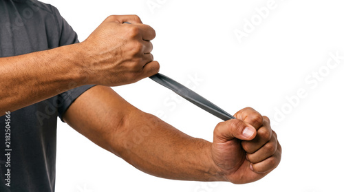 Foto Grey resistance band pulled diagonally between two muscular arms crossing over s