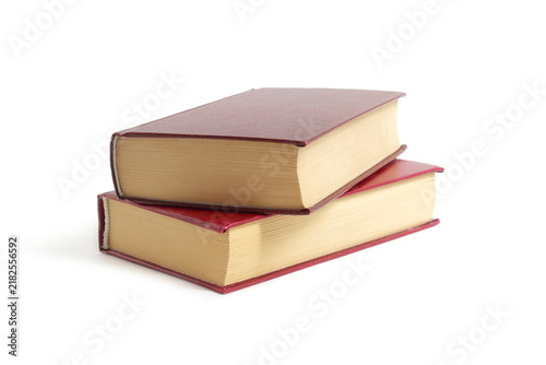 Two old books lie on a white background.