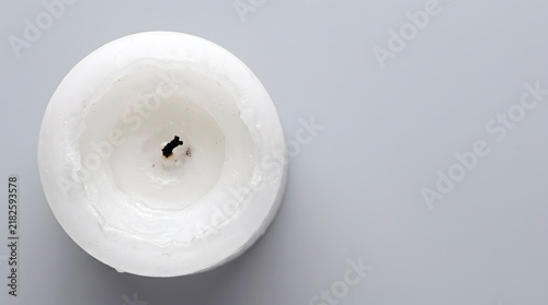 Completely burned out candle with charred wick, conceptual mental burnout and consumed energy.